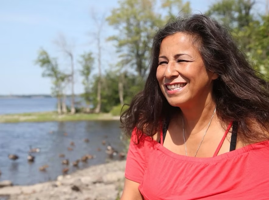 Lynda Kitchikeesic smiling near the shoreline
